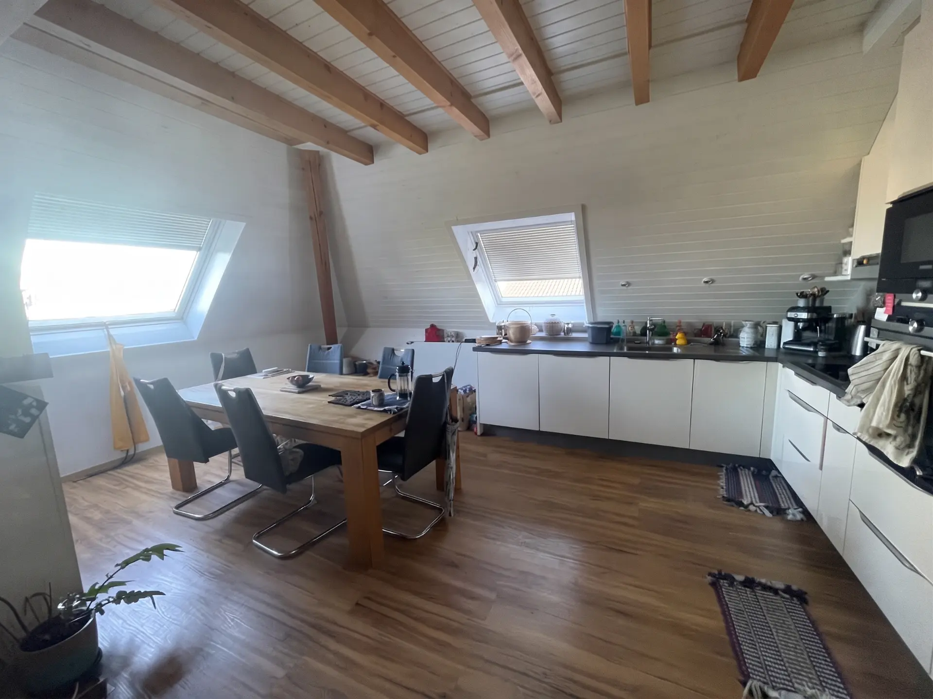 Kitchen listing photo before real estate editing: dull light and cluttered worktop